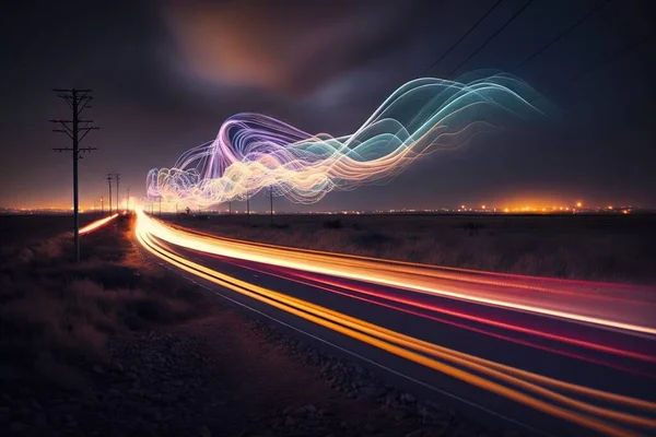 a long exposure photo of a road at night with a long exposure of light painting on the road and the road lights streaking across the road.