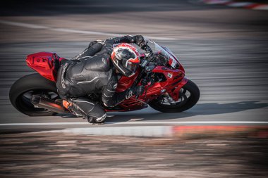  Kırmızı motosikletli bir adam yarış pistinde hareket halinde. üretici ai