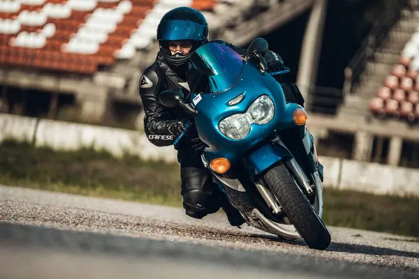  Mavi motosikletli bir adam caddede bir binanın yanında. üretici ai