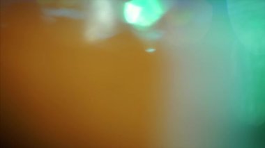 Multi-colored neon futuristic psychedelic iridescent background in green and orange palette. 3840x2160p 4k footage for creative use. 