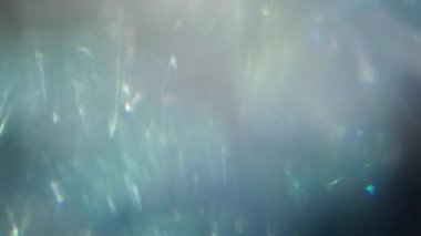 Holographic flashes, futuristic elegant highlights, rainbow shimmers of colors and shades. Cold palette, 4k footage in high quality.