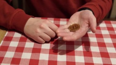 Concept of paying with bitcoin in a public place: in a restaurant, cafe. Bitcoin in the male palm. Man holding in hand symbol of crypto currency. Cryptocurrency golden bitcoin coin. 4K 2160p 25fps