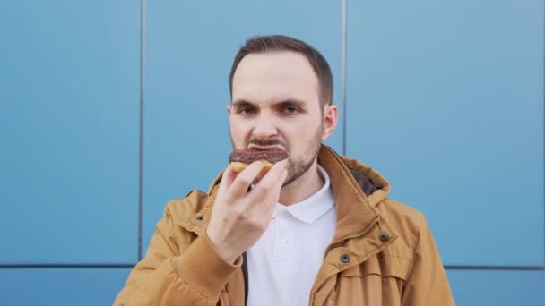 Hungry Man Mustache Beard Eats Chocolate Donut Blue Background Close — Video Stock