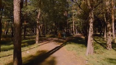 Old grandfather is roller skating. Granddaughter roller-skating with grandfather.
