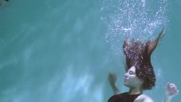 女と男が水中で泳いでいる 女性が水中で男にキス — ストック動画