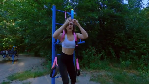 一名妇女正在使用一个伸展弹性带的运动橡胶模拟器 运动肌肉训练用橡皮筋 — 图库视频影像