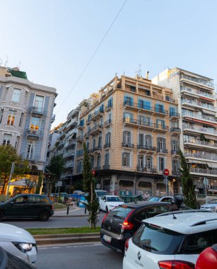 Selanik, Yunanistan, 23 Ekim 2024. Deniz kenarındaki bir bulvarda ve gezinti alanında araba trafiği. Selanik 'in turizm beldesinde dükkanlar ve konut binaları.