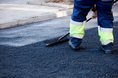 asphalt in the city operators working with tools and uniform clipart