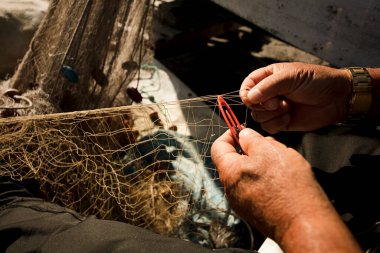Balıkçıların elinde balık ağı ve iğnenin detaylı görüntüsü