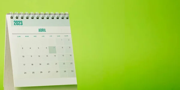 Desk calendar for the month of April 2023 with bright green background