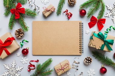 Christmas blank greeting card mock-up scene. Creative layout made of Christmas tree branches and paper card note. Flat lay. Nature New Year concept.