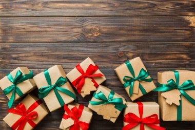 Colored craft gift boxes with colorful ribbons on colored background. Collection of Christmas present boxes .