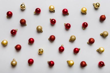 Christmas composition. a pattern of christmas balls on colored background. Flat lay, top view New year decor.