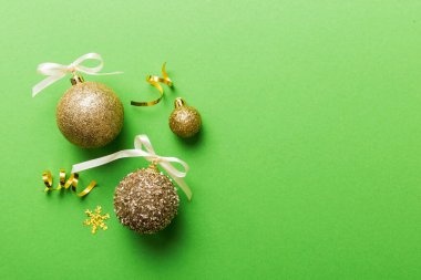 Christmas ball on colored background. decoration bauble with ribbon bow with copy space.