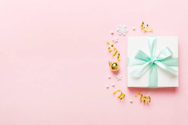Top view Flat lay Christmas decorations and gift box on colored background with copy space. Christmas or Happy New Year composition.
