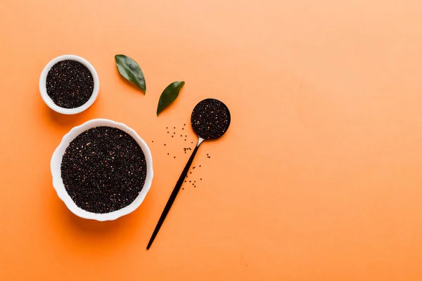 stock image quinoa seeds in bowl and spoon on colored background. Healthy kinwa in small bowl. Healthy superfood.