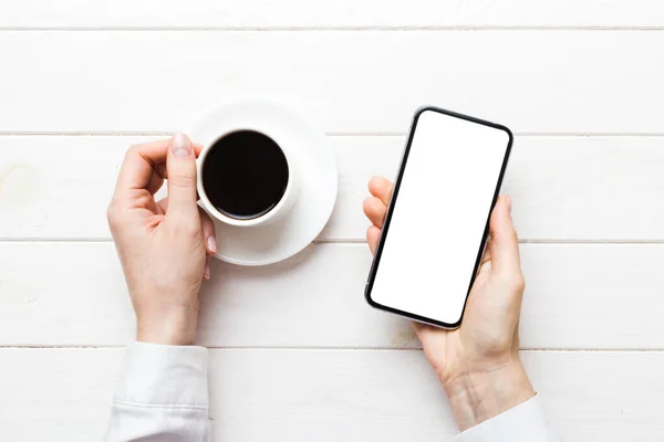 stock image Top view of woman hands holding smart phone with blank copy space screen for your text message or information content. woman hand using phone white screen on top view.