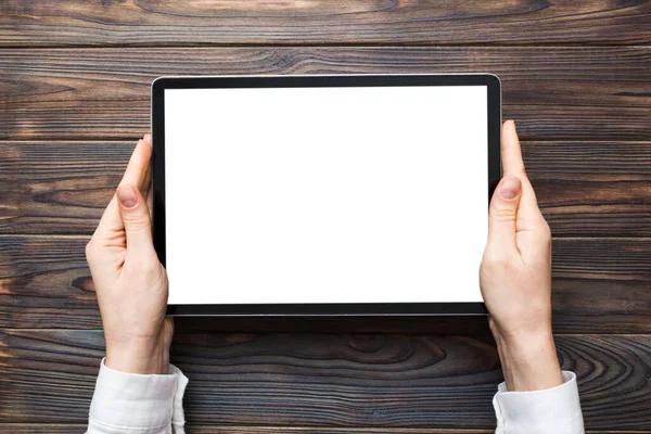 stock image female teen hands using tablet pc with white screen, Mockup image of woman hand holding white tablet pc with blank white screen at home.