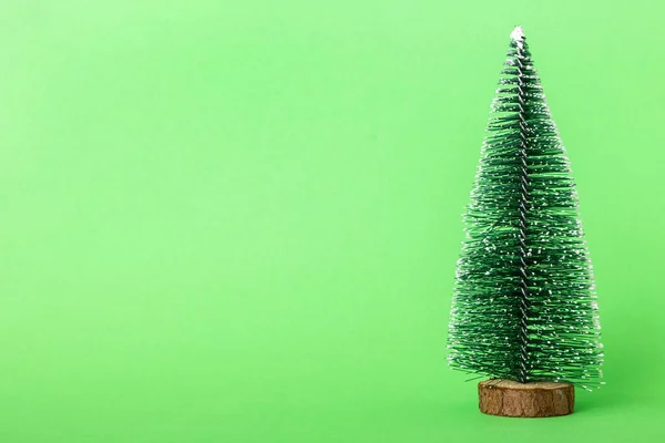 Stock image One small Christmas tree on colored background. new year decoration with copy space.