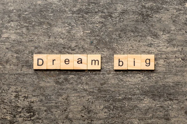 Dream big word written on wood block. Dream big text on cement table for your desing, Top view concept.