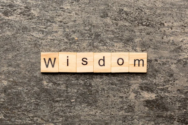 Tahta blokta yazan bilgelik kelimesi. Masada bilgelik metni, konsept.