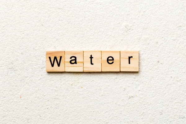 Water Word Written Wood Block Water Text Cement Table Your — Stock Photo, Image