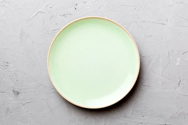 stock image Top view of empty green plate on cement background. Empty space for your design.