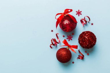 Christmas ball on colored background. decoration bauble with ribbon bow with copy space.