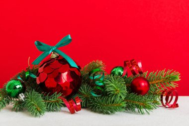 New Year Christmas tree toy, branches of a christmas tree, New Year decorations on a colored background.