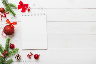 Christmas blank greeting card mock-up scene. Creative layout made of Christmas tree branches and paper card note. Flat lay. Nature New Year concept.