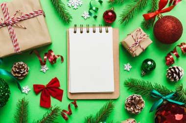 Christmas blank greeting card mock-up scene. Creative layout made of Christmas tree branches and paper card note. Flat lay. Nature New Year concept.