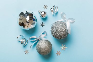 Christmas ball on colored background. decoration bauble with ribbon bow with copy space.