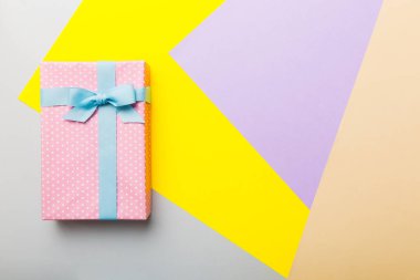 holiday handmade paper present tied blue ribbon bow top view with copy space. Flat lay holiday background. Birthday or christmas present. Christmas gift box concept with copy space.