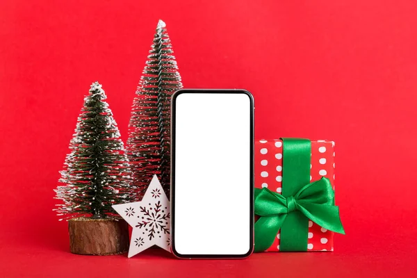 stock image Digital phone mock up with rustic Christmas decorations for app presentation with empty space for you design. Christmas online shopping concept. Tablet with copy space on colored background.