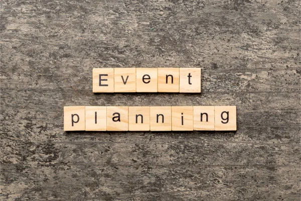 Event planning word written on wood block. Event planning text on table, concept.