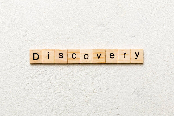 discovery word written on wood block. discovery text on table, concept.