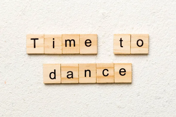 time to dance word written on wood block. time to dance text on cement table for your desing, concept.
