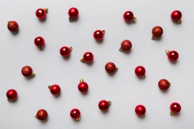 Christmas composition. a pattern of christmas balls on colored background. Flat lay, top view New year decor.