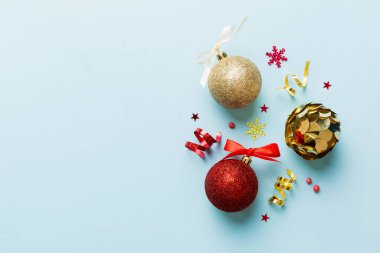 Christmas ball on colored background. decoration bauble with ribbon bow with copy space.