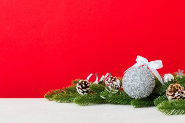 New Year Christmas tree toy, branches of a christmas tree, New Year decorations on a colored background.