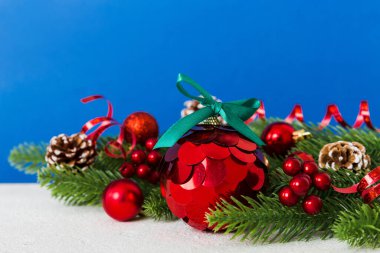 New Year Christmas tree toy, branches of a christmas tree, New Year decorations on a colored background.