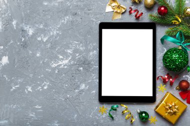 Digital tablet mock up with rustic Christmas decorations for app presentation top view with empty space for you design. Christmas online shopping concept. Tablet with copy space on colored background.