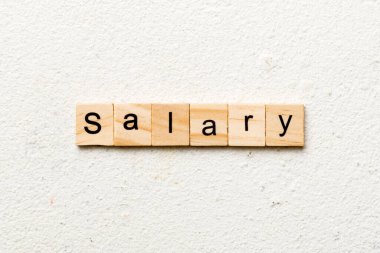 salary word written on wood block. salary text on table, concept.