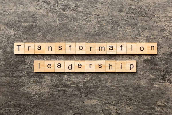 transformation leadership word written on wood block. transformation leadership text on cement table for your desing, concept.