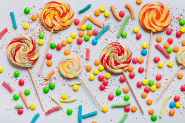 Lezzetli İştah açıcı Parti Aksesuarları Mutlu Yıllar Tatlı. Renkli arkaplanda farklı tipte şekerler, kopyalama alanı. Renkli doğum günü partisi geçmişi.