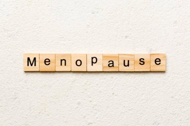 menopause word written on wood block. menopause text on table, concept. clipart