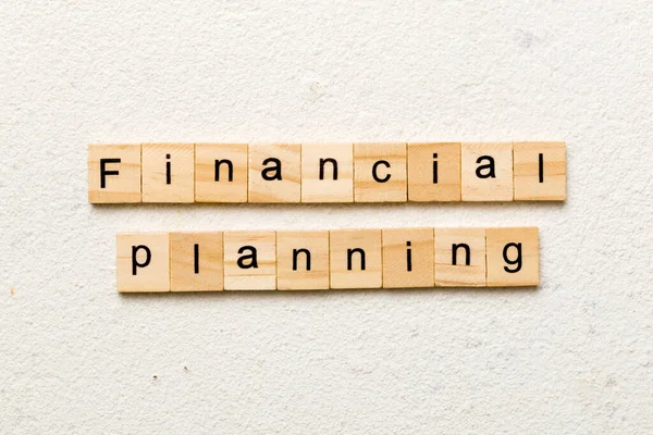 financial planning word written on wood block. financial planning text on cement table for your desing, concept.