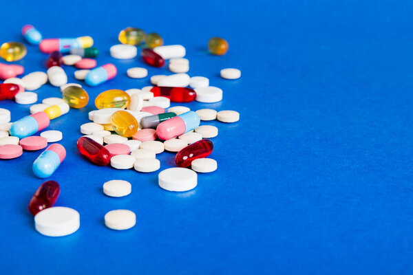 Many different colorful medication and pills perspective view. Set of many pills on colored background.