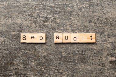 seo audit word written on wood block. seo audit text on table, concept.