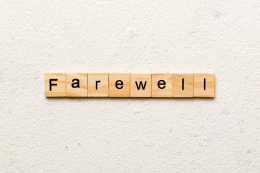 farewell word written on wood block. farewell text on table, concept. clipart